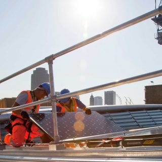 workers installing solar panels Blackfriars bridge